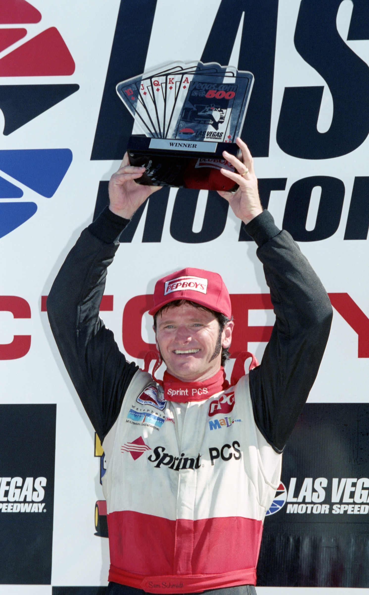 Sam Schmidt lifting the winner's trophy at Las Vegas Motor Speedway, 1999